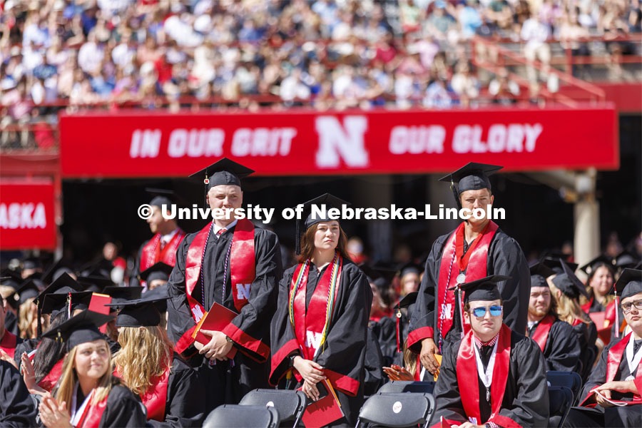 Graduates who have served in the military stand and are honored during the UNL undergraduate commencement in Memorial Stadium. May 14, 2022. Photo by Craig Chandler / University Communication.