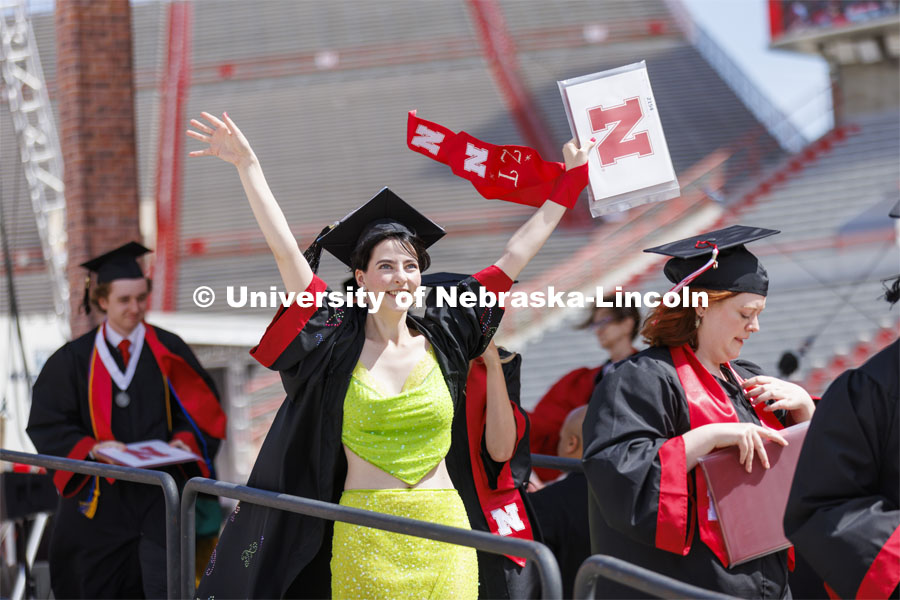Kira Taylore waves to family and friends after receiving her diploma. UNL undergraduate commencement in Memorial Stadium. May 14, 2022. Photo by Craig Chandler / University Communication.
