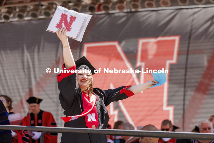 Katelynn Meadows waves to her family as receiving her diploma. UNL undergraduate commencement in Memorial Stadium. May 14, 2022. Photo by Craig Chandler / University Communication.