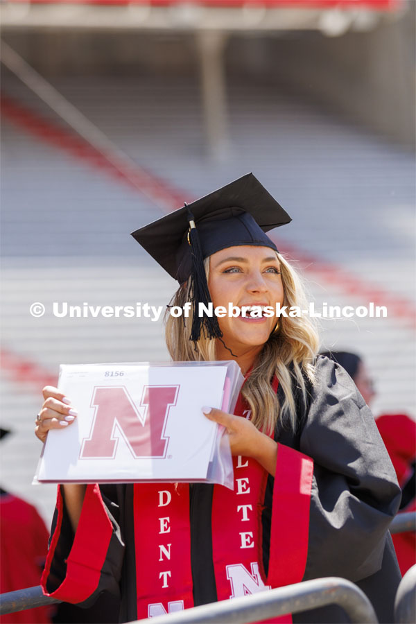 Nicole Hansen, College of Business, graduate, smiles to her family and friends after receiving her diploma. UNL undergraduate commencement in Memorial Stadium. May 14, 2022. Photo by Craig Chandler / University Communication.