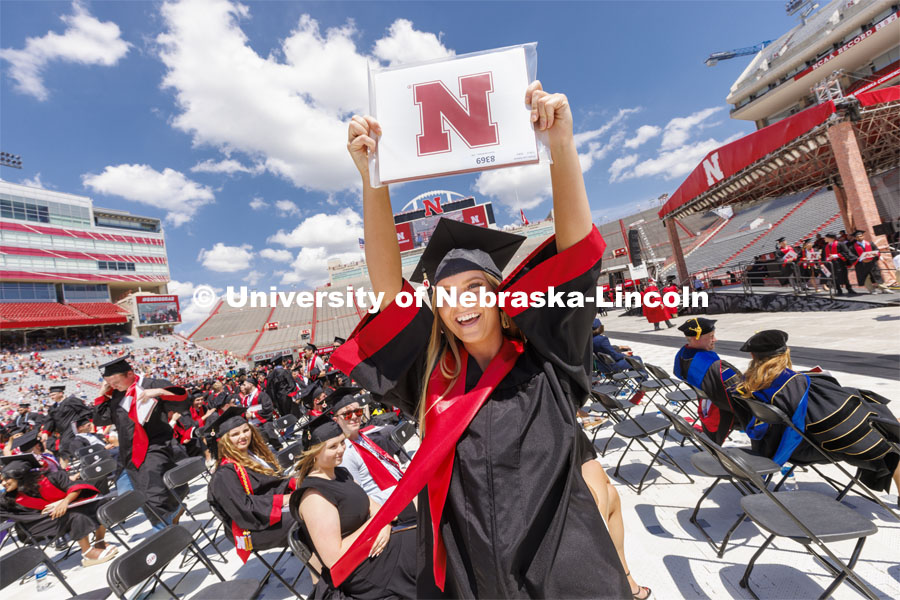 Kirsten Roberts shows off her College of Business diploma to friends and family. UNL undergraduate commencement in Memorial Stadium. May 14, 2022. Photo by Craig Chandler / University Communication.