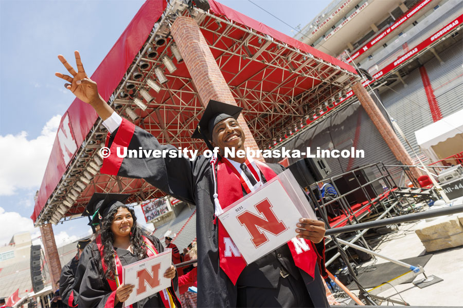 Savant Nzayiramya waves to family and friends after receiving his CASNR diploma. UNL undergraduate commencement in Memorial Stadium. May 14, 2022. Photo by Craig Chandler / University Communication.