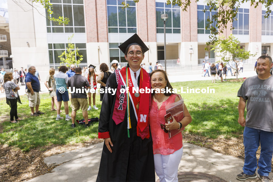 Antonio Linhart and family pose for photos following the UNL undergraduate commencement in Memorial Stadium. May 14, 2022. Photo by Craig Chandler / University Communication.