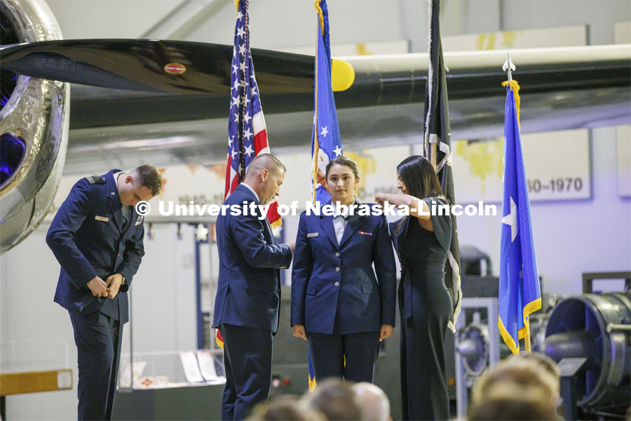 Second Lt. Alyssa Mahon has her bars pinned onto her uniform by his parents. The university’s Air Force ROTC detachment held a commissioning for May graduates at the Strategic Air Command and Aerospace Museum in Ashland. May 16, 2022. Photo by Craig Chandler / University Communication.