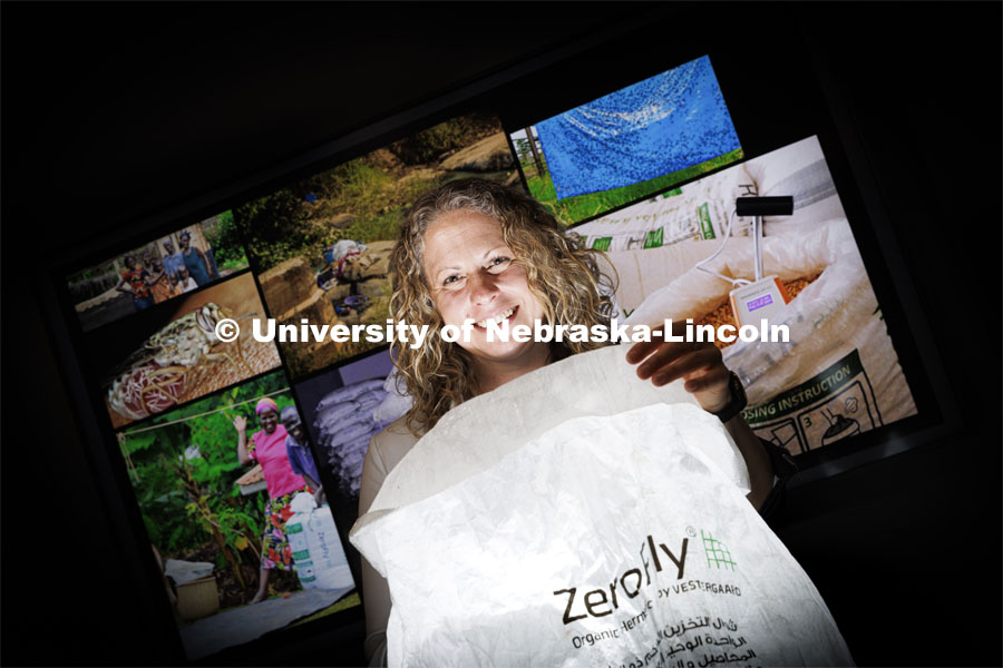 Georgina Bingham, research associate professor of entomology at Nebraska, holds an airtight, insect-resistant storage bag known as a ZeroFly® Hermetic bag with insecticide incorporated to prevent damaging pest infestations. She led the development of the bags while working for the Swiss company Vestergaard. It reduces the loss of seeds or grains that can be consumed, stored for security, or sold for optimized prices. It is said to be free of the hazards associated with fumigation or the potential for pesticide residues that come from inaccurate insecticide spraying. The insecticide is incorporated into individual fibers of the bags, which provides a killing action before insects can infest the grain or seed packed in the bag a bag. May 26, 2022. Photo by Craig Chandler / University Communication.