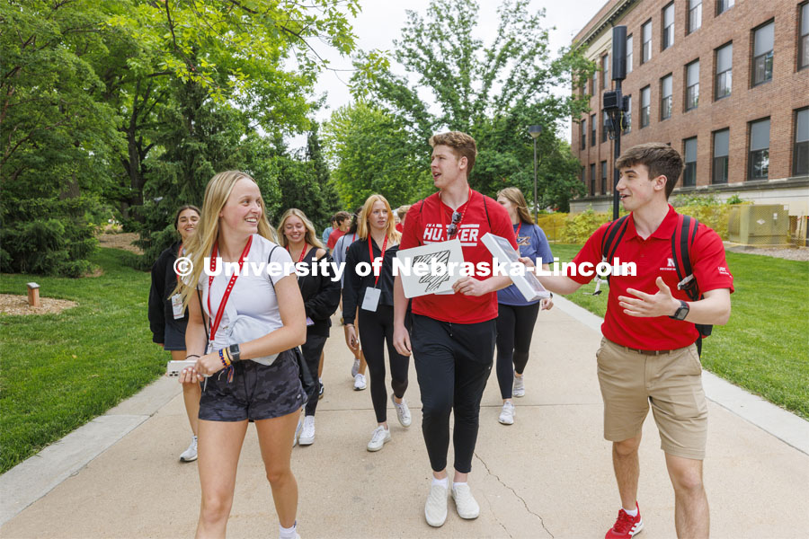 A group of NSE students led by Jack Kinney walk across campus. New Student Enrollment. June 1, 2022. Photo by Craig Chandler / University Communication.