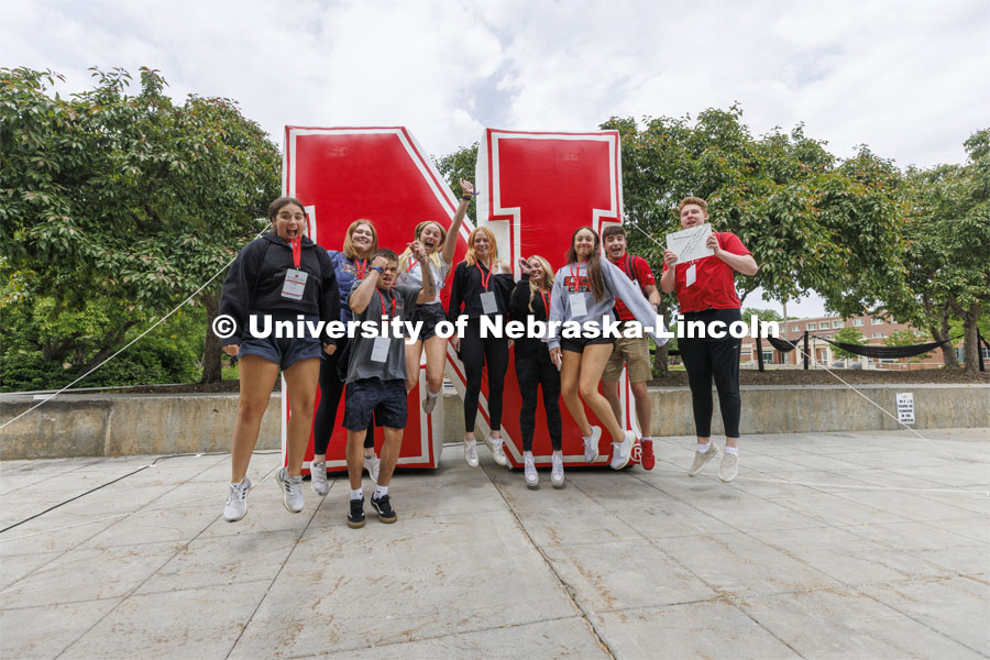 Jack Kinney’s NSE group leaps in front of the inflatable N sculpture on the Union Plaza after touring campus. New Student Enrollment. June 1, 2022. Photo by Craig Chandler / University Communication.