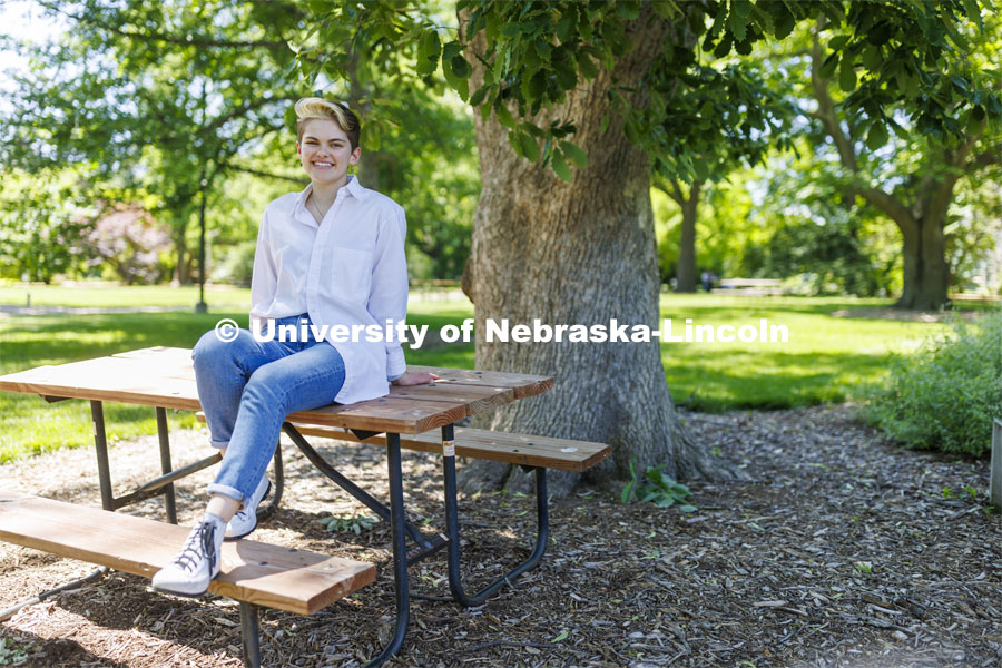 Ally Barry, a junior in environmental studies, sits in the arboretum on East Campus, one of her favorite places on campus.  Photo for her PRIDE month feature story. June 3, 2022. Photo by Craig Chandler / University Communication. 