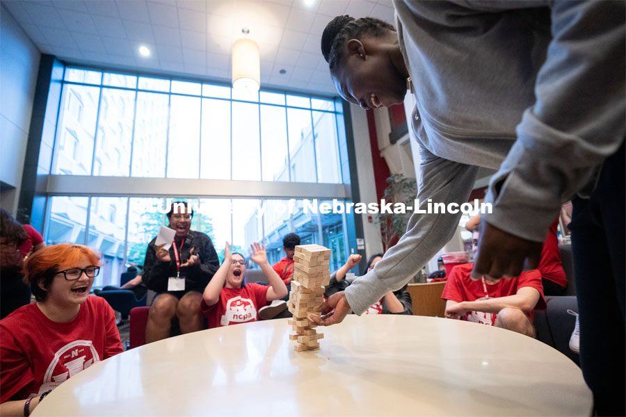 Attendees take turns removing blocks during a game of Jenga at the Nebraska College Preparatory Academy’s Science Camp inside Abel Hall. NCPA, a program for academically talented, first-generation, income eligible students to help prepare them for college and their future careers. June 9, 2022. Photo by Jordan Opp for University Communication.
