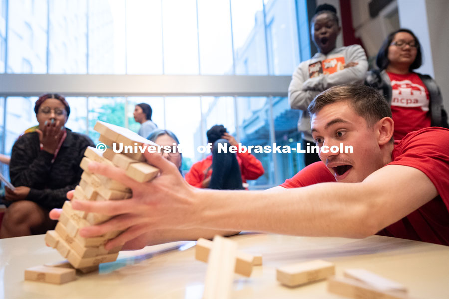 John Clark (right) reacts after tipping a Jenga tower during the Nebraska College Preparatory Academy’s Science Camp inside Abel Hall. NCPA, a program for academically talented, first-generation, income eligible students to help prepare them for college and their future careers. June 9, 2022. Photo by Jordan Opp for University Communication.