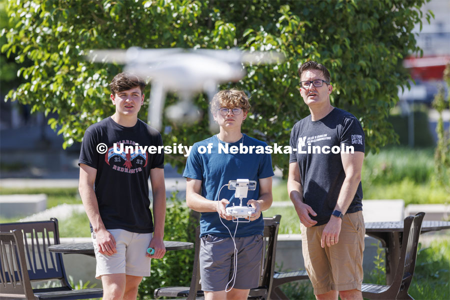 Journalism professor Matt Waite, watches as Lincon (sp) Kuhn of North Platte launches a drone. Miles Durkin of Chicago is at left. Waite was demonstrating drone flying to high school students in the 4-H Digital Media Big Red Academic Camp. June 16, 2022. Photo by Craig Chandler / University Communication.