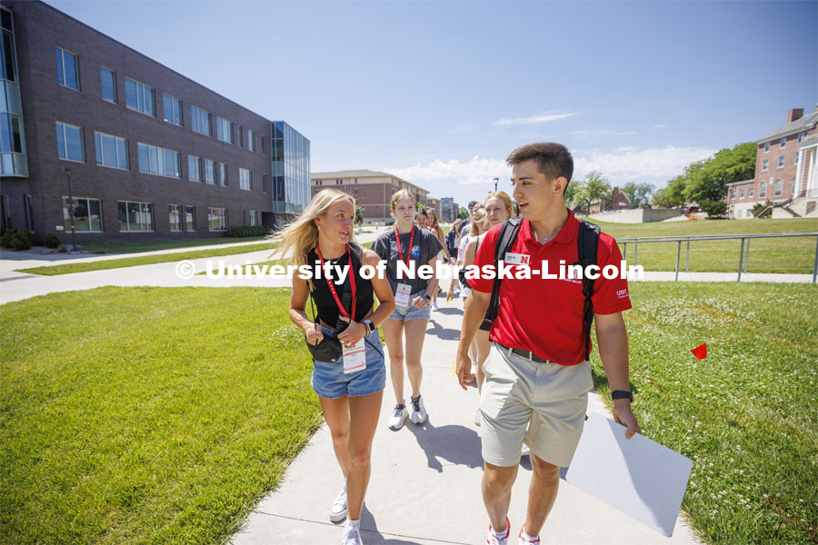 Erin Sheehy of Hastings talks with New Student Orientation Leader Trenton Hammond as his group tours campus. NSE Leaders walking on campus with their student groups. June 16, 2022. Photo by Craig Chandler / University Communication.