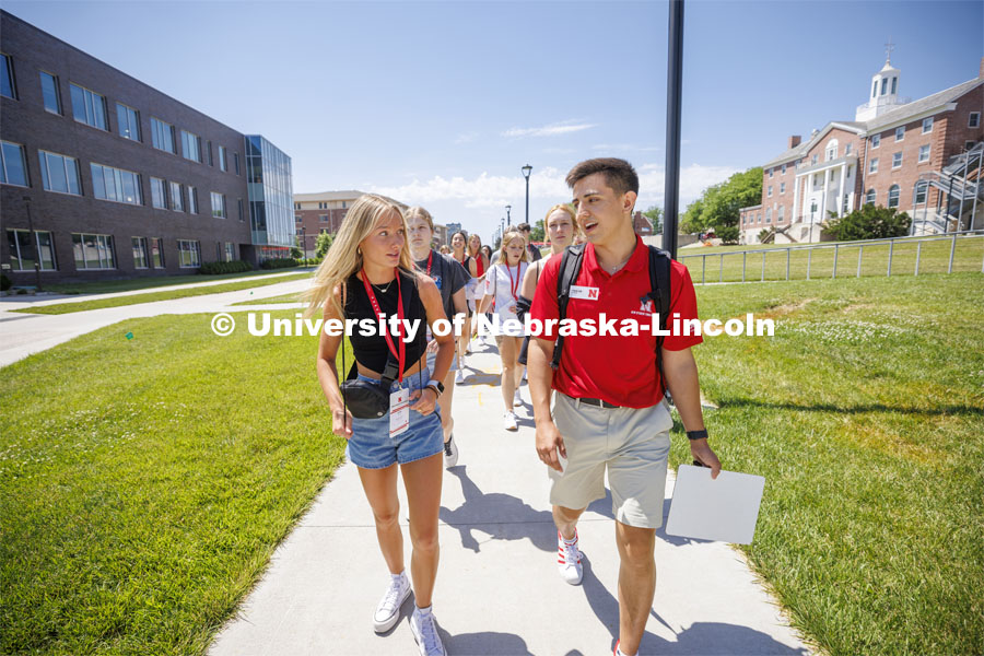Erin Sheehy of Hastings talks with New Student Orientation Leader Trenton Hammond as his group tours campus. NSE Leaders walking on campus with their student groups. June 16, 2022. Photo by Craig Chandler / University Communication.