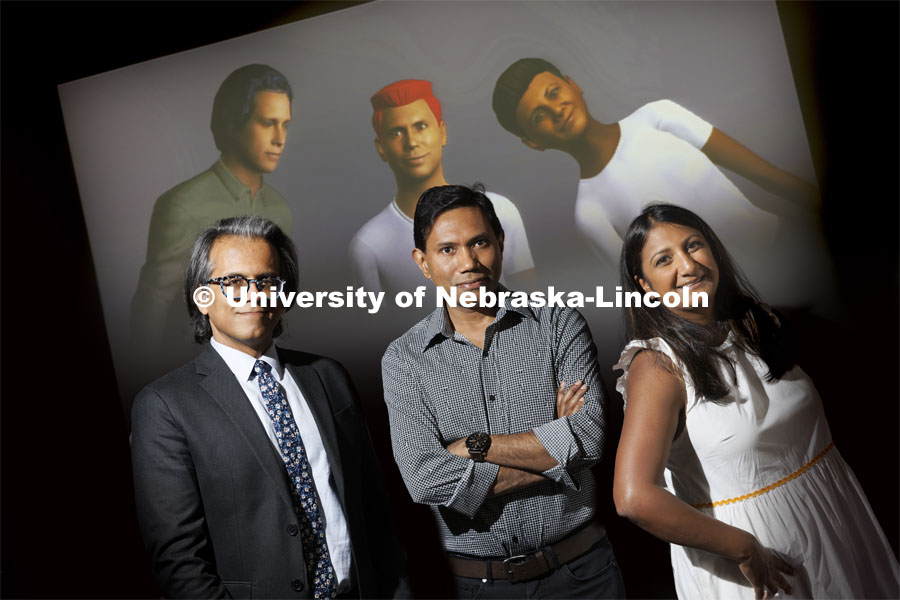 (From left) Bilal Khan, Mohammad Hasan and Neeta Kantamneni are watched by their doppelgangers. The researchers are developing an artificial intelligence-based app called Messages from a Future You, for STEM students with targeted, real-time interventions that boost their performance in STEM courses. The students will be able to talk to a doppelganger of themselves to keep them motivated and know what to focus on during the semester. June 22, 2022. Photo by Craig Chandler / University Communication.