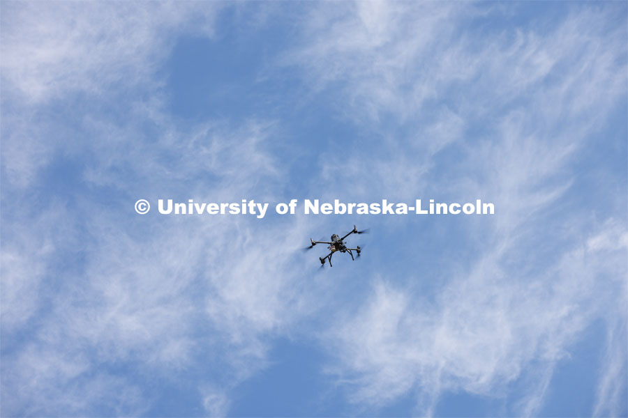 An autonomous drone photographs a field of triticale at the research fields at 84th and Havelock. Biological Systems Engineering fieldwork with drones for phenotyping fields. June 27, 2022. Photo by Craig Chandler / University Communication.