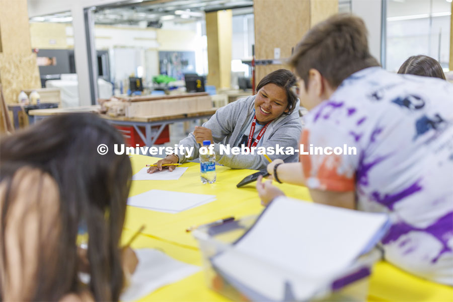 Alana Denney laughs while looking at images for her design with academy mentor Shiloh King. 2022 MATC/NCIA Sovereign Native Youth STEM Leadership Academy. June 30, 2022. Photo by Craig Chandler / University Communication.