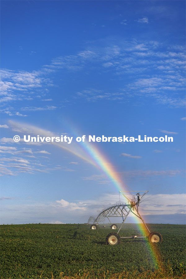 A center pivot northeast of Adams, Nebraska makes a rainbow in the evening sunlight. July 1, 2022. Photo by Craig Chandler / University Communication.