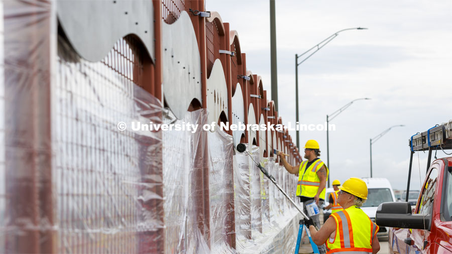 Reni Buehler rolls while Dirk Edwards edges the wave-patterned artwork on the overpass. Building Systems Maintenance paints the artwork on the overpasses of North Antelope Valley Parkway and Salt Creek Roadway. July 7, 2022. Photo by Craig Chandler / University Communication.