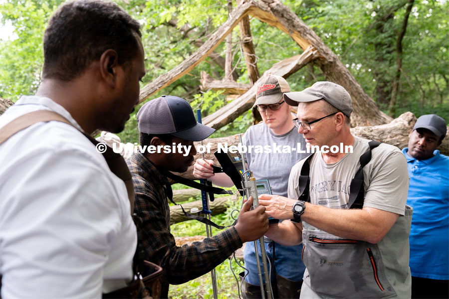 Research Engineer Alan Boldt (right) helps students assemble tools to measure the water flow rates of Salt Creek at Wilderness Park. Irrigation Laboratory and Field Course class trip to Salt Creek at Wilderness Park. July 8, 2022. Photo by Jordan Opp for University Communication.