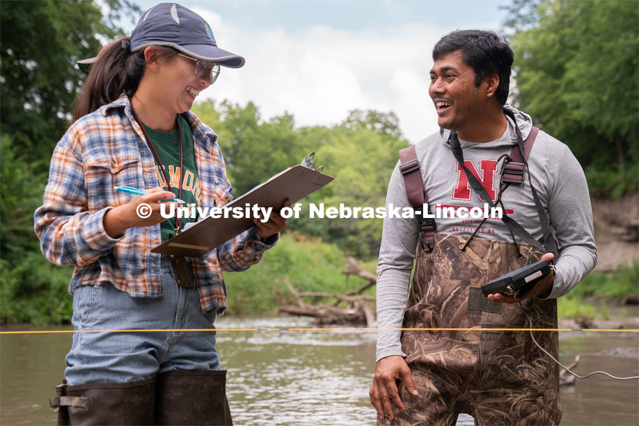 Jamie Duan(left) and Amit Kumar Rai (right) laugh during their Irrigation Laboratory and Field Course class trip to Salt Creek at Wilderness Park. July 8, 2022. Photo by Jordan Opp for University Communication.