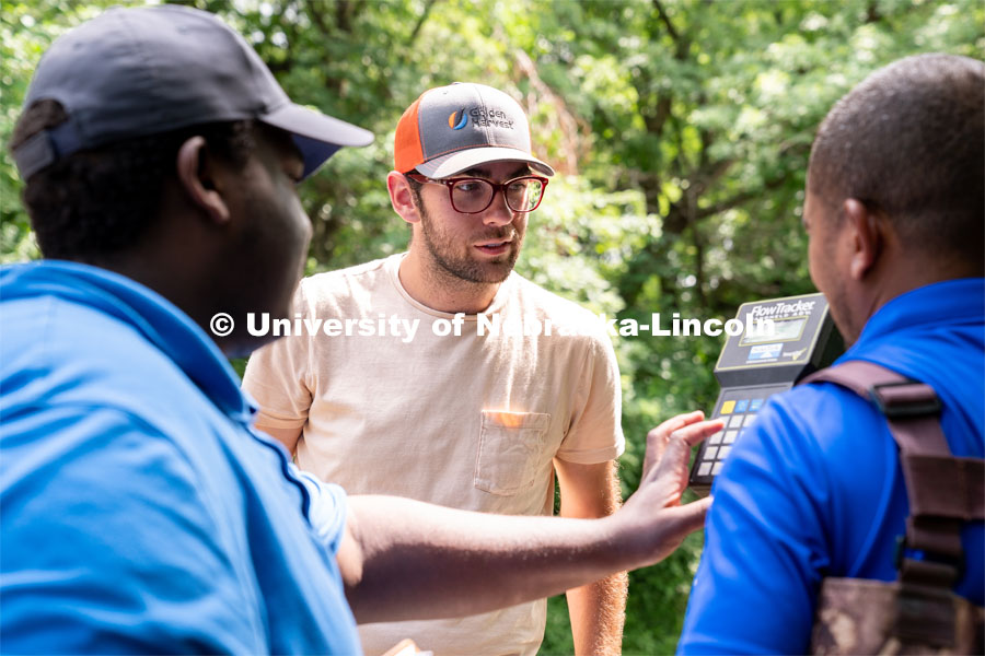 Eric Wilkening (center) watches as data is being read from a FlowTracker machine during the Irrigation Laboratory and Field Course class trip to Salt Creek at Wilderness Park. July 8, 2022. Photo by Jordan Opp for University Communication.