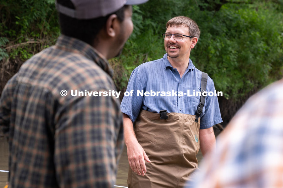 Professor Derek Heeren laughs with students during his Irrigation Laboratory and Field Course class trip to Salt Creek at Wilderness Park. July 8, 2022. Photo by Jordan Opp for University Communication.