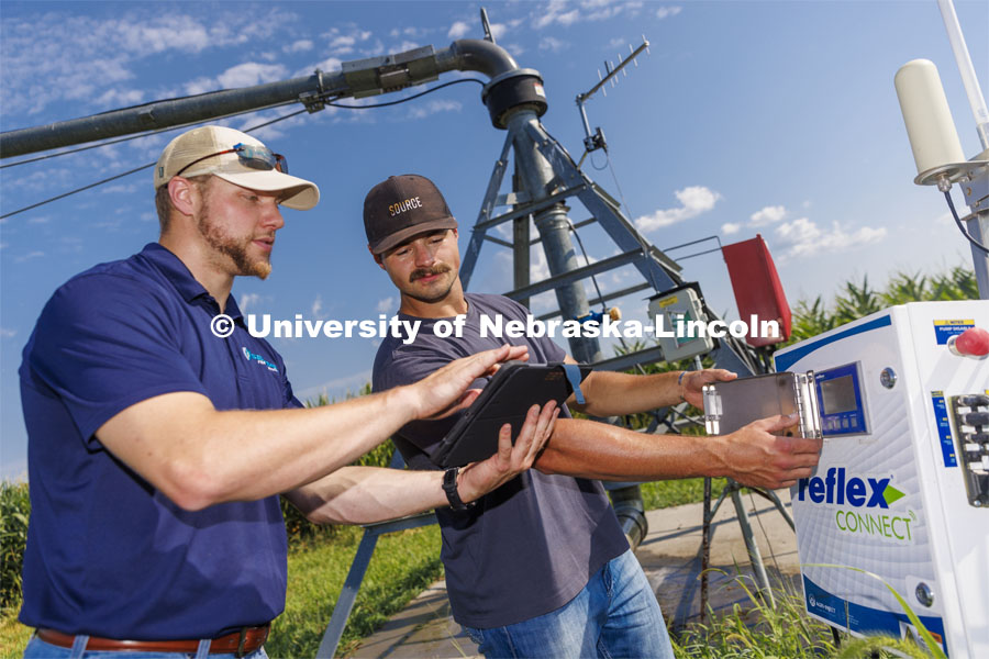 Jackson Stansell, founder and CEO of Sentinal Fertigation, goes over field data with Brett Gerdes, senior in agronomy and intern at Sentinal Fertigation, who is entering data into the pump system of a pivot using fertigation technology at ENREC near Mead, Nebraska. . August 3, 2022. Photo by Craig Chandler / University Communication.
