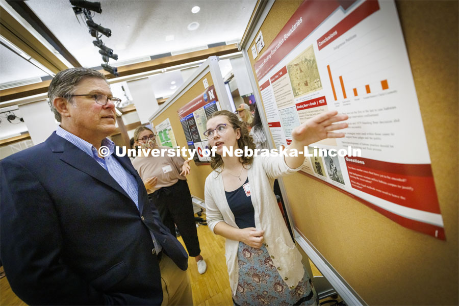 Samantha Byrd, a senior in history, discusses her summer research of habeas corpus and reservation boundaries with Will Thomas at the poster fair. Poster fair for Nebraska Summer Research Program in Nebraska Union ballroom. August 5, 2022. Photo by Craig Chandler / University Communication.