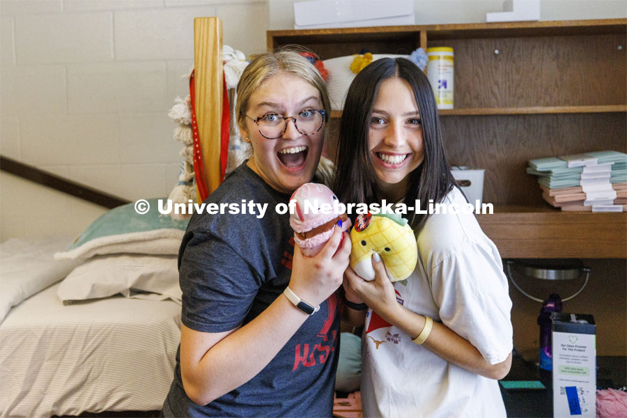 Eden McQueen of Phoenix, AZ, left, and Zoey Zeller of North Sioux City, South Dakota, show off their squishmallows after they both realized they each brought one to the campus. Residence Hall move in for students participating in Greek Rush. August 14, 2022. Photo by Craig Chandler / University Communication.