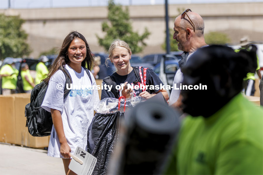 Lily Tobin, left, and Stella Minge, both of Omaha, watch their possessions head for their Schramm Hall room. Residence Hall move in for students participating in Greek Rush. August 14, 2022. Photo by Craig Chandler / University Communication.