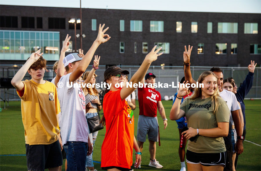 Students raise their hands during the Playfair activity at the Vine Street Fields Wednesday night as part of Big Red Welcome. August 17, 2022. Photo by Gus Kathol for University Communication.