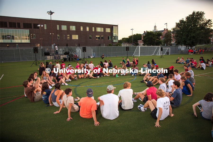 Students sit in a circle during the Playfair activity at the Vine Street Fields Wednesday night as part of Big Red Welcome. August 17, 2022. Photo by Gus Kathol for University Communication.