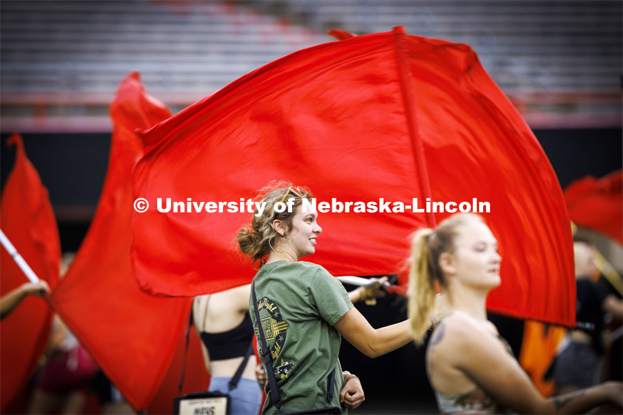 Color guard member Karli Crawford practices the pregame. Cornhusker Marching Band practice in Memorial Stadium under the lights. August 18, 2022. Photo by Craig Chandler / University Communication.