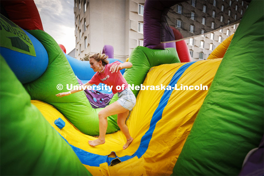 Students tumble through the inflatable obstacle course at Harper Schramm Smith residence halls block party. August 18, 2022. Photo by Craig Chandler / University Communication.