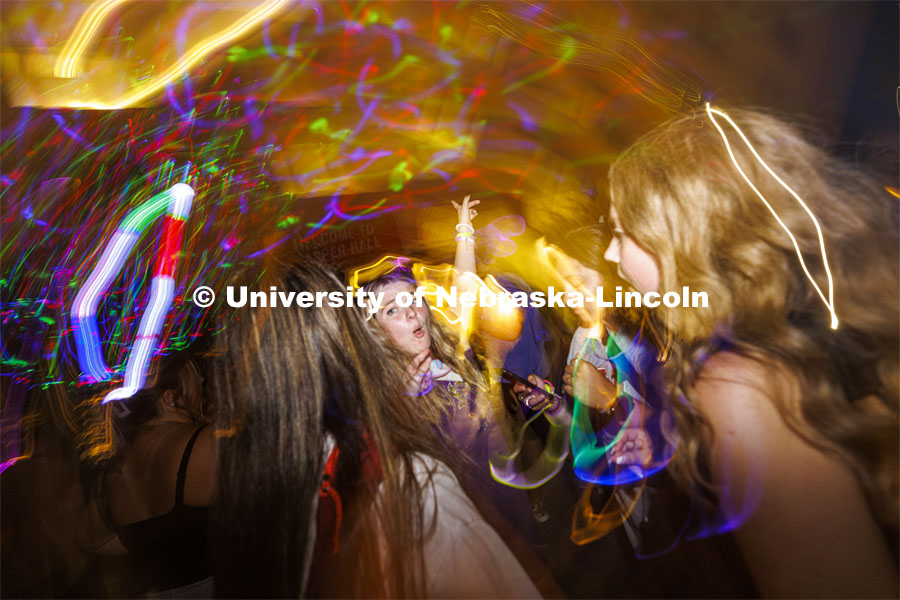 Lydia Hernandez, a freshman from Omaha, smiles as she dances with her friends at the Harper Schramm Smith residence halls block party. August 18, 2022. Photo by Craig Chandler / University Communication.