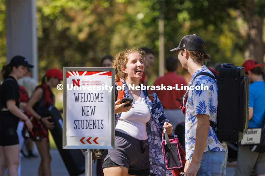 Lara Celesky talks with Brock Godown as the Cornhusker Marching Band Members grab a bite to eat the Hixon-Lied College Welcome for new and returning students. Big Red Welcome - College Welcome Programs. August 18, 2022. Photo by Craig Chandler / University Communication.