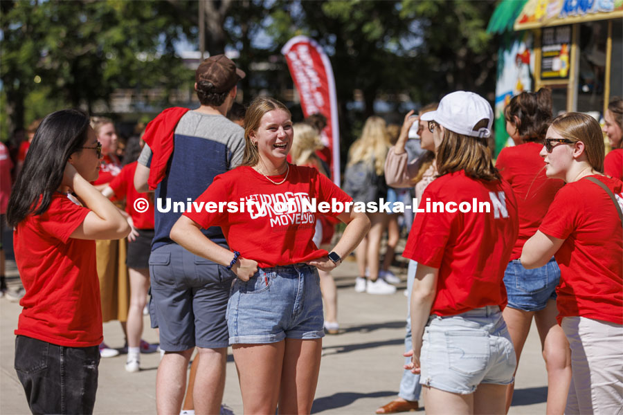 Brigid Toomey, a sophomore from Charlotte, North Carolina, talks with friends at the College of Arts and Sciences College Welcomes for new and returning students. Big Red Welcome - College Welcome Programs. August 18, 2022. Photo by Craig Chandler / University Communication.