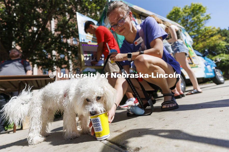 8-month-old Bailey eats his own Kona Ice along with his owner Zoie Malesker, a junior from Omaha, at the College of Arts and Sciences event for new and returning students. Big Red Welcome - College Welcome Programs. August 18, 2022. Photo by Craig Chandler / University Communication.