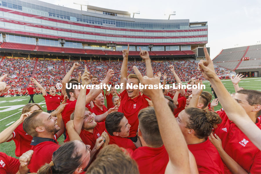 Drew Carlson, a freshman trumpet player from North Platte, is hoisted in the arms of the trumpet section after winning the drill down competition. Big Red Welcome week featured the Cornhusker Marching Band Exhibition in Memorial Stadium where they showed highlights of what the band has been working on during their pre-season Band Camp, including their famous “drill down”. August 19, 2022.  Photo by Craig Chandler / University Communication.