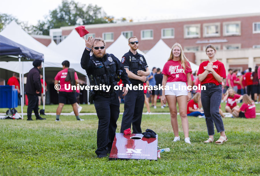 UNL Police Department officers play cornhole at the Chancellor’s BBQ to welcome the class of 2026 in the greenspace by the Nebraska Union. August 19, 2022. Photo by Craig Chandler / University Communication.