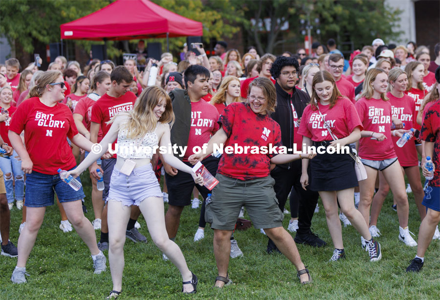 A group of students including Sam Pharris, a freshman from Aberdeen, South Dakota, dance at the Chancellor’s BBQ to welcome the class of 2026 in the greenspace by the Nebraska Union. August 19, 2022. Photo by Craig Chandler / University Communication.