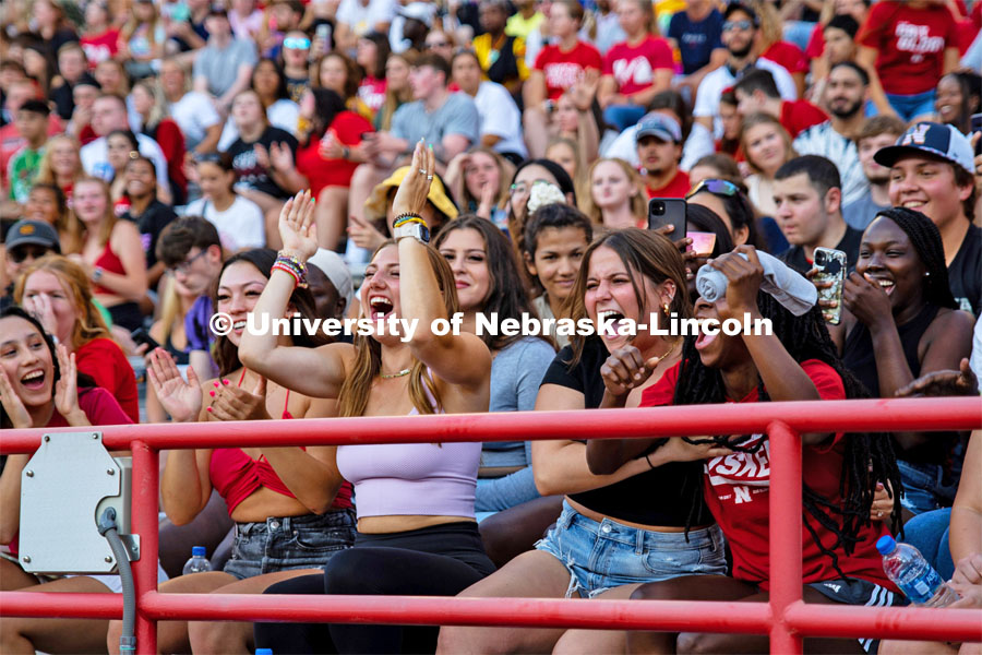 UNL students cheering as they catch a t-shirt at the Boneyard Bash in Memorial Stadium. August 20, 2022. Photo by Kirk Rangel for University Communication.