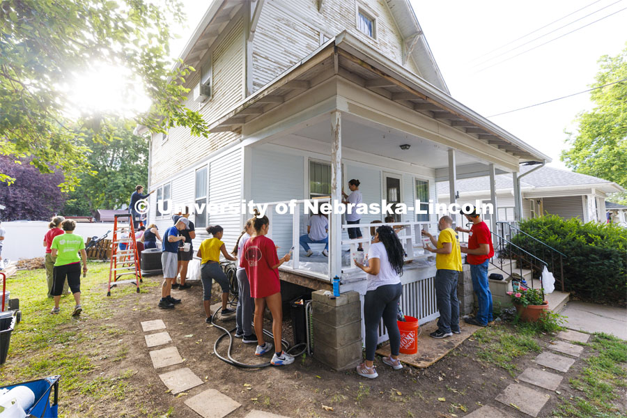 First-year law students, faculty, staff and family members come together to paint a house at 518 S. 26th Street. Photo by Craig Chandler / University Communication.