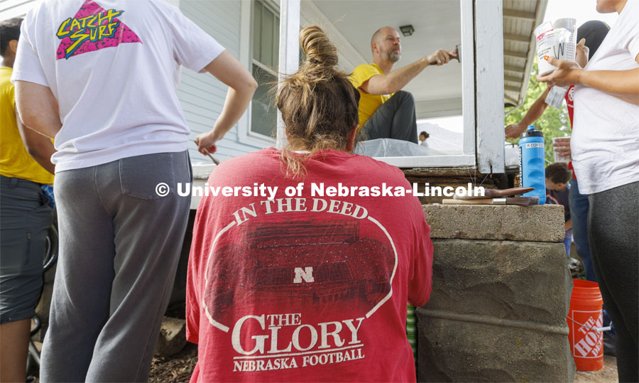 First-year law students, faculty, staff and family members come together to paint a house at 518 S. 26th Street. Photo by Craig Chandler / University Communication.