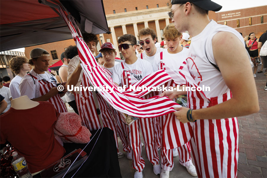 Students on Smith Residence Hall’s tenth floor admire the striped overalls they all wore to the Street Fest. Sunday, the Street Fest filled the parking lot by East Stadium with hundreds of booths hosted by local businesses, nonprofit organizations, UNL departments and plenty of music, free food, giveaways and prizes. August 21, 2022. Photo by Craig Chandler / University Communication.