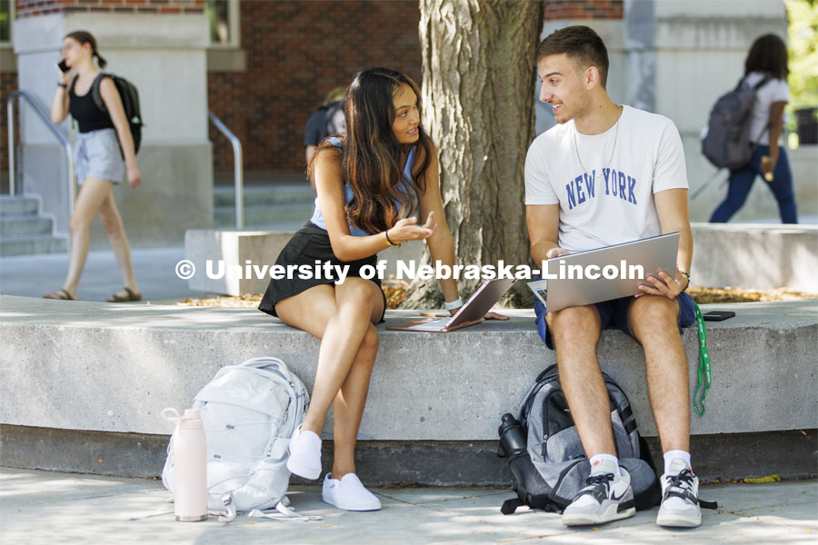 Dinushi Jayasekara, left, a freshman from Omaha, and Eldin Salja, a freshman from Lincoln, talk outside the Union. First day of classes. August 22, 2022. Photo by Craig Chandler / University Communication.