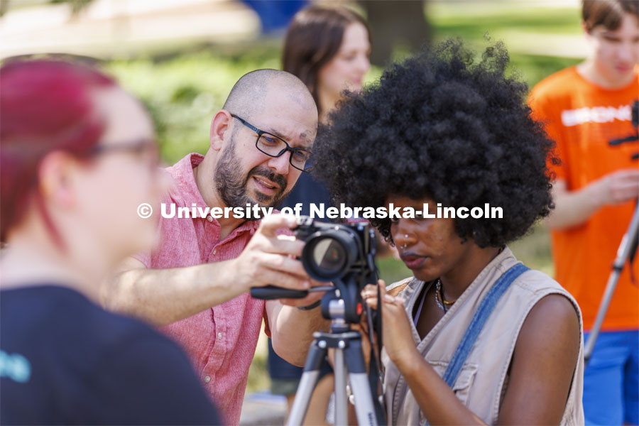 Walker Pickering talks about camera settings with Ella Gbetanou, a junior from Omaha, during PHOT 161 - Photography for Non-majors course. The class was doing a photo assignment in the Sheldon Sculpture Garden. August 24, 2022. Photo by Craig Chandler / University Communication.