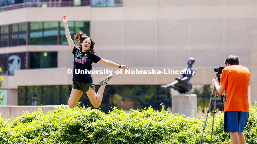 Leah Rathe, a junior from Lincoln, leaps through the air for her photo partner, Joshua Rodriguez, a freshman from Lincoln. The leap was for the stop action portion of the assignment. Walker Pickering leads his PHOT 161 - Photography for Non-majors course with a photo assignment in the Sheldon Sculpture Garden. August 24, 2022. Photo by Craig Chandler / University Communication.
