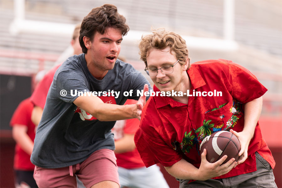 Husker fans play a game of football at the Nebraska vs Northwestern football watch party in Memorial Stadium. August 27, 2022. Photo by Jordan Opp for University Communication.