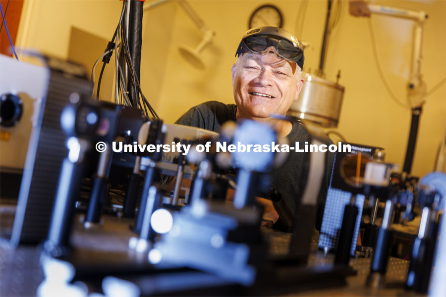 Nebraska’s Cornelis “Kees” Uiterwaal removes the Microsoft HoloLens 2, a headset that allows its wearers to view and interact with computer-generated objects in the physical world. The associate professor of physics and astronomy is collaborating with fellow scientists and multimedia artists to design augmented-reality experiences that help explain the bizarre, sometimes-counterintuitive realm of quantum physics. Uiterwaal was awarded one of the three Grand Challenges major grants for his proposal to increase education of quantum physics using augmented reality. August 29, 2022. Photo by Craig Chandler / University Communication.